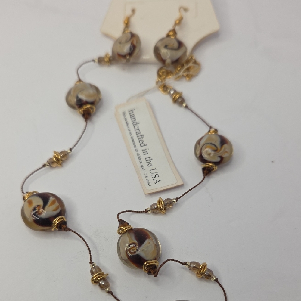 Jewelry set features brown and white swirled glass beads with Swaroski Crystals